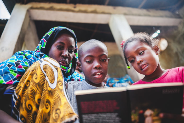 african Child doing her homework with her mother